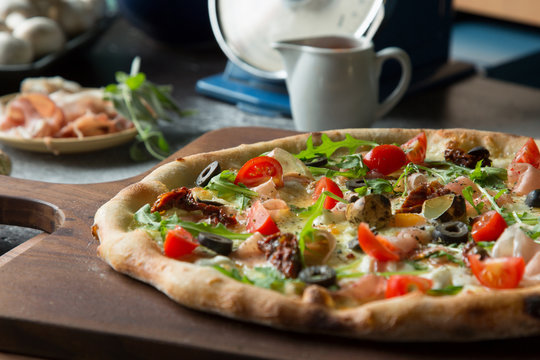 Italian pizza with cherry tomato, black olive and eggs