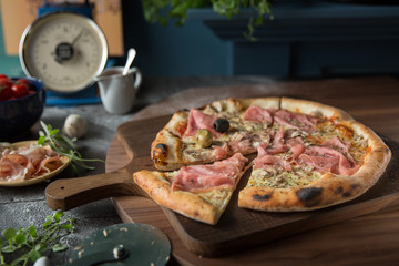 Italian pizza with salami and olives