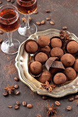 Whiskey or liqueur, truffle chocolate candies in cocoa powder