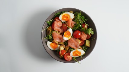 Salmon, egg, arugula, baked potato and tomato salad
