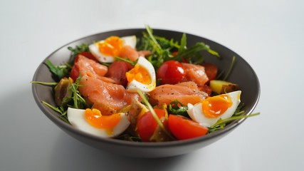 Salmon, egg, arugula, baked potato and tomato salad
