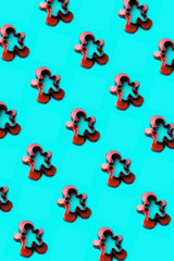 Plastic form for cutting a gingerbread man standing on a blue emerald background. Christmas minimal creative concept in trendy retro pop art colors. Classical neo vertical composition. Minimal design 