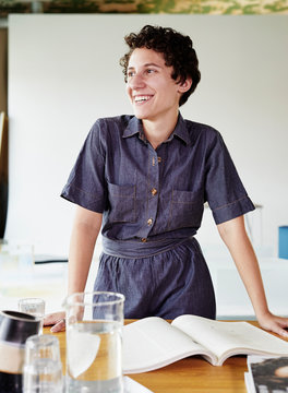 Smiling woman in a day lite office.