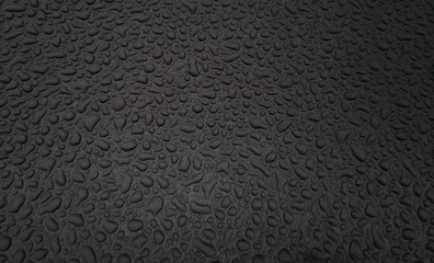 Beautiful background texture of rain water drops on grey black metal surface. Beautiful backgrounds. Drops of water on a color background. Dark grey.