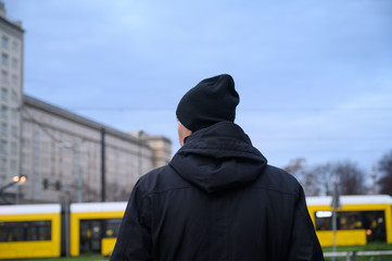 Rear view of a man looking at something. Berlin, Germany.