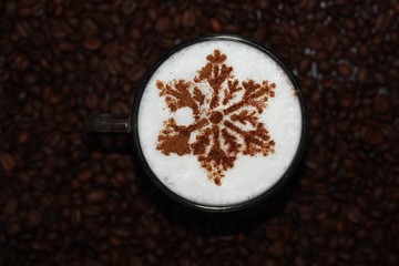 Christmas cappuccino with cinnamon and coffee beans