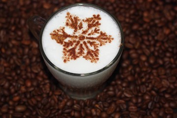 Christmas cappuccino with cinnamon and coffee beans