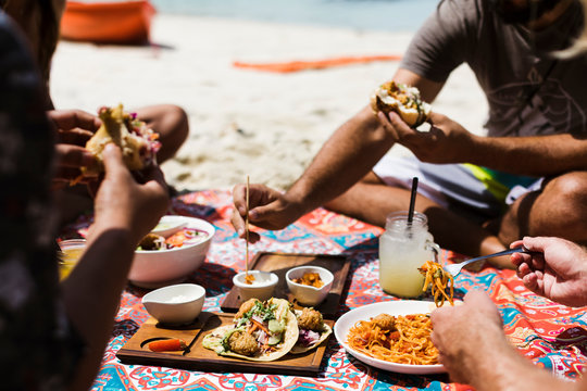 People sharing vegan food on the beach