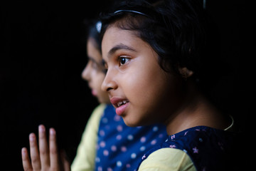Portrait of cute little girl looking away with reflection at mirror