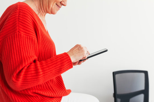 Mature businesswoman working in the office - Powered by Adobe