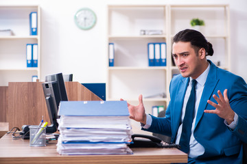 Young handsome businessman sitting in the office