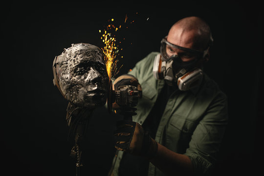 Artisan shaping metal bust with grinder