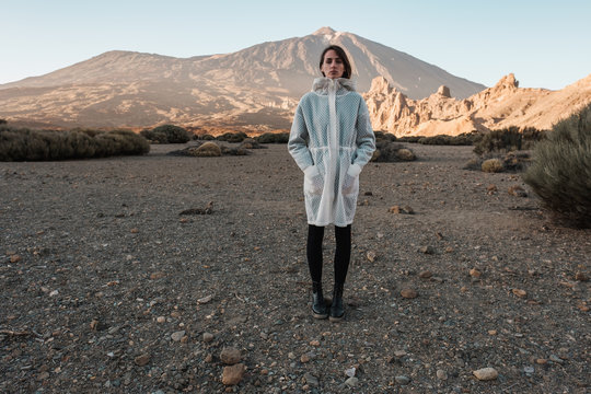 Portrait Of Female Model Wearing White Coat In The Volcanic Scenery