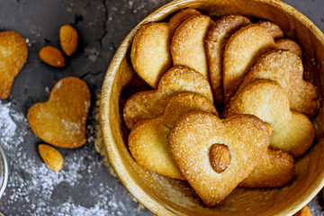 Walnut cookies. Homemade almond flour heart cookies on a dark background.