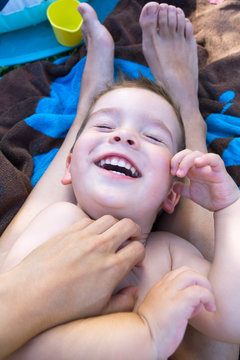 Boy laughing while being tickled