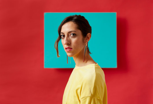 Portrait of a young woman in front of a colorful background