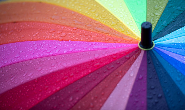 Close Up Of Rainbow Colored Umbrella In Mild Rain