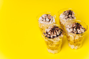 Cakes with white cream on a yellow background. Baking and sweets.