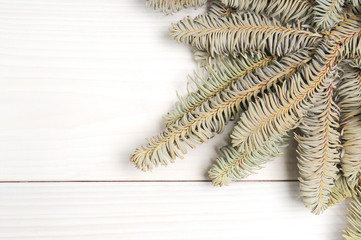 Christmas white wooden pattern with Christmas tree branches and toys