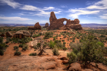 hiking in arches national park we look behind us on the trail and get a gorgeous view of the classic turret arch © Charles
