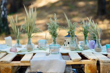 Boho style party decor in the forest. Party decoration for a bachelorette party.