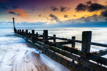 Groyne on the beach in Mundesley in North NOrfolk in the UK at sunset