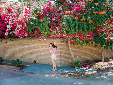 Mom walking with daughter on sidewalk