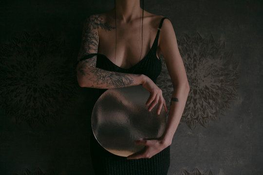 beautiful girl posing on a gray background and drapery