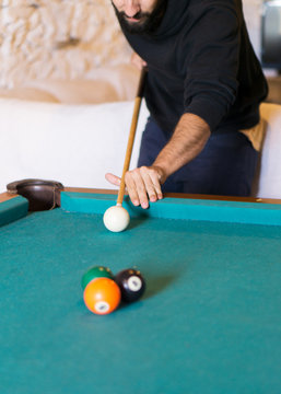 Man Playing Billiards In A Pool Table