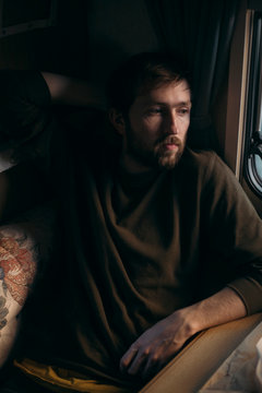 portrait of hipster guy in a sweater against a dark background