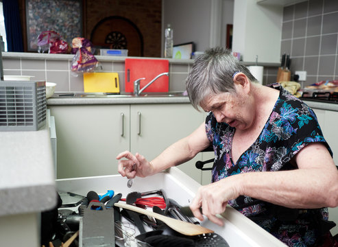 Woman Sorting a Cutlery Drawer