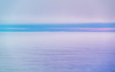 Purple sunrise or sunset above the clouds