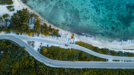 boat parking on the beach of caribbean sea shot with drone