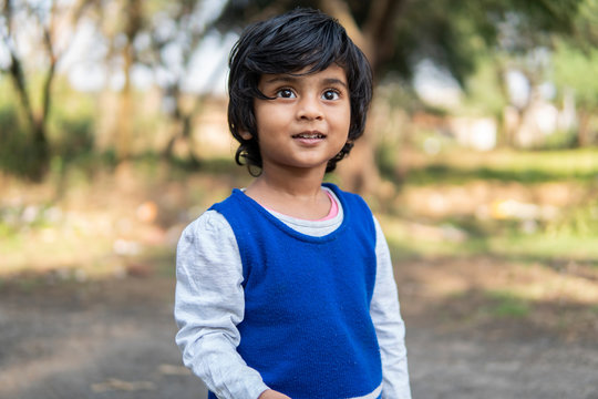 Outdoor portrait of little girl smiling and making fun