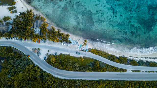boat parking on the beach of caribbean sea shot with drone