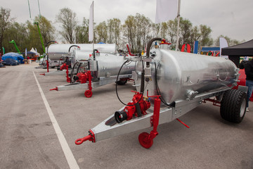 Farm business fair with manure tankers.