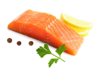Red fish. Raw salmon fillet with parsley, peppercorns and lemon isolate on white background