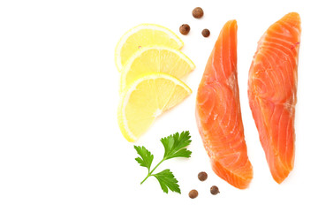 Red fish. Raw salmon fillet with parsley, peppercorns and lemon isolate on white background. Top view