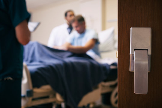 Hospital: Focus On Patient Room Door With Exam Going On Inside