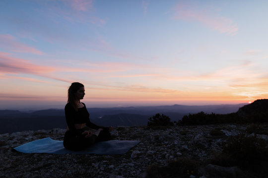 Woman Doing Yoga on Mountain Cliff