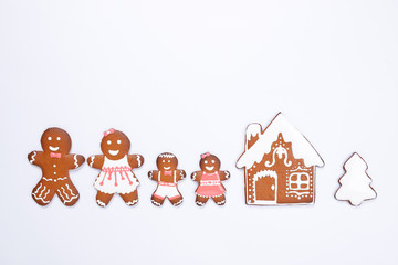 The hand-made eatable gingerbread house, little men on white background