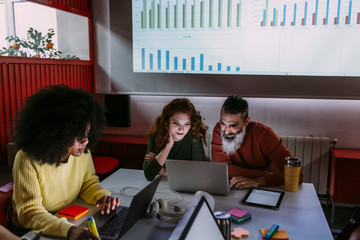 Afro casual woman using laptop in meeting room