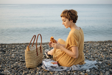 Woman having picnic alone on beach