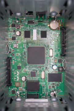 Electronic components on a green motherboard