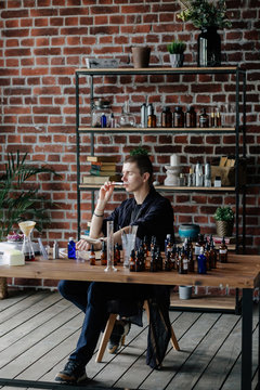 Professional man preparing perfume