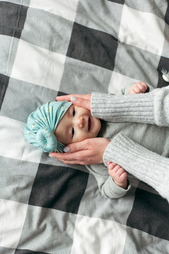 mom pats baby in the face
