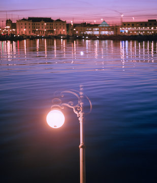 Night City over water behind street lamp