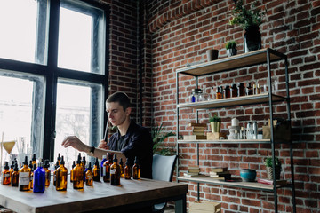 Professional man preparing perfume