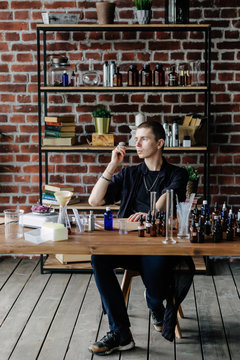 Professional man preparing perfume