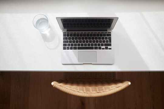 Table with computer and glass of water